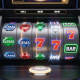 Vibrant online slot machine interface with spinning reels, showing abstract winning symbols and subtle digital security graphics, representing certified fair play and RNG integrity.