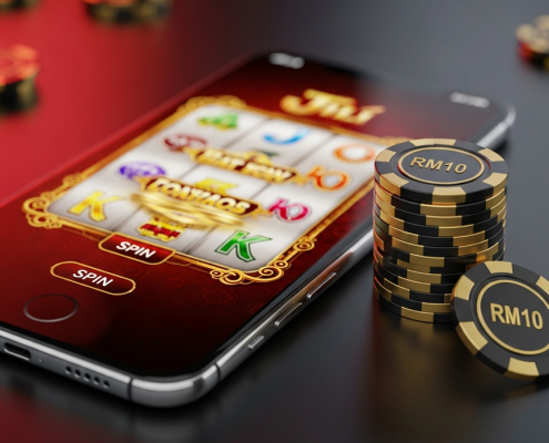 A smartphone displaying a Jili-style slot game next to a small stack of casino chips, illustrating strategic bankroll management for a RM10 budget.