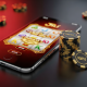 A smartphone displaying a Jili-style slot game next to a small stack of casino chips, illustrating strategic bankroll management for a RM10 budget.