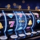 Illustration: slot machine reels with “RNG” on the middle reel, surrounded by gems, sevens and bells.